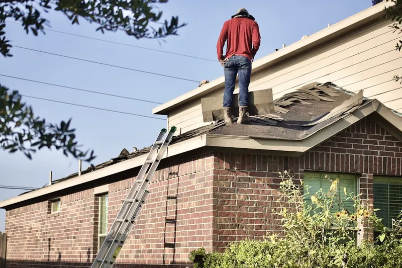 Professional roofer working on a residential roof in Pioneer Square